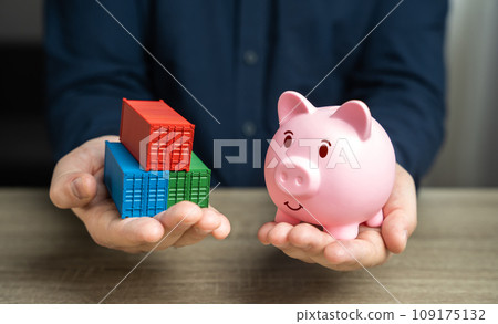 Shipping containers and piggy bank in hands. Potential for financial savings in trade. Logistics prowess in optimizing financial expenditures. Economizing, accumulating savings. Save money on shipment 109175132