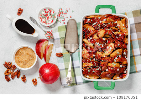 Baked Apple French Toast topped with pecan nuts 109176351
