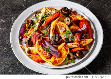baked winter veggies and mushrooms on a plate baked winter veggies and mushrooms on a plate 109176352