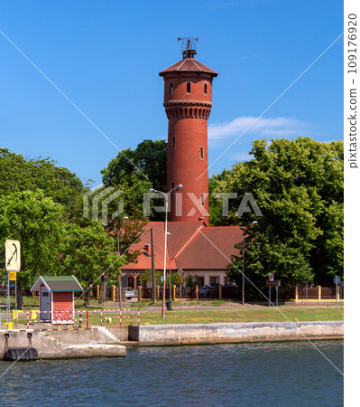 Swinoujscie. Old brick water tower on the bay embankment. Swinoujscie. Old brick water tower on the bay embankment. 109176920