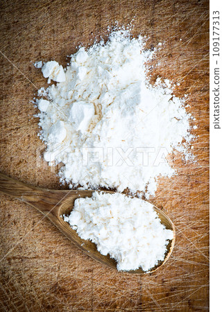 flour in a wooden spoon flour in a wooden spoon 109177313