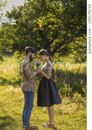 couple in nature with wildflowers couple in nature with wildflowers 109178239