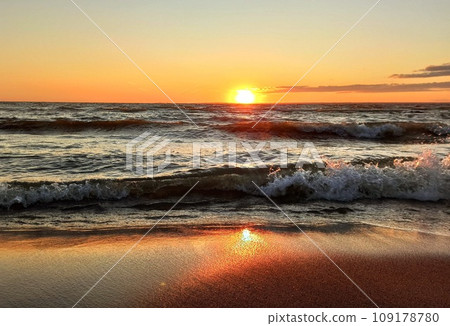 reflection of the sun on the sand and a strong wave 109178780