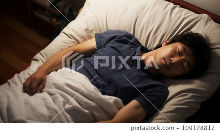 Young Japanese man sleeping in bed Young Japanese man sleeping in bed 109178812