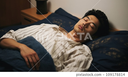 Young Japanese man sleeping in bed Young Japanese man sleeping in bed 109178814