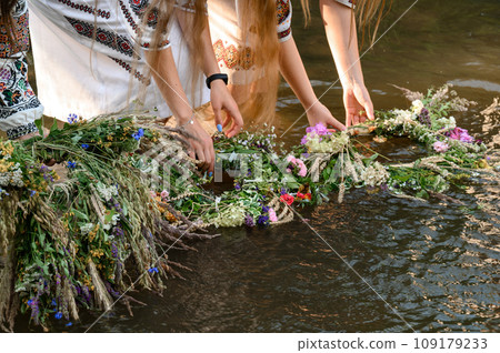 Fortune-telling on wreaths and water, the Ivan Kupala holiday, girls throw wreaths on the water. 109179233