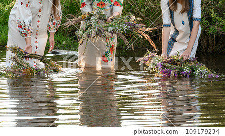 Fortune-telling on wreaths and water, the Ivan Kupala holiday, girls throw wreaths on the water. Fortune-telling on wreaths and water, the Ivan Kupala holiday, girls throw wreaths on the water. 109179234