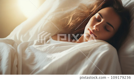 Pretty Caucasian woman sleeps calmly under blanket on soft bed at home closeup 109179236
