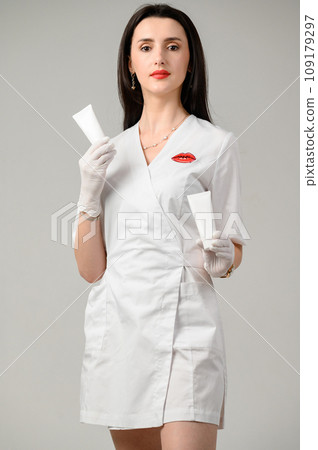 The girl holds a skin care cream in her hands. The girl holds a skin care cream in her hands. 109179297