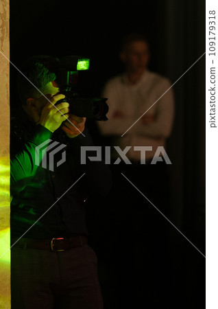 A photographer at work, the process of shooting and photographing celebrations. Paparazzi conducts a journalistic investigation at a party. A photographer at work, the process of shooting and photographing celebrations. Paparazzi conducts a journalistic investigation at a party. 109179318