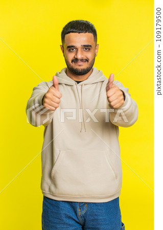 Indian man raises thumbs up agrees or gives positive reply recommends advertisement likes good idea Indian man raises thumbs up agrees or gives positive reply recommends advertisement likes good idea 109179500