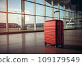 Red suitcase in an airport hallway 109179549