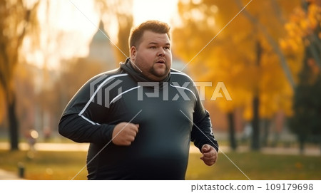 Young Caucasian man jogging through the empty autumn park. Young Caucasian man jogging through the empty autumn park. 109179698