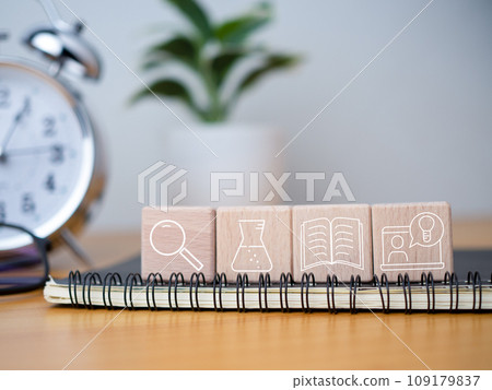 Educational concept Creativity and innovation Square wooden blocks are arranged together with educational icons on top of a notebook. Educational concept Creativity and innovation Square wooden blocks are arranged together with educational icons on top of a notebook. 109179837