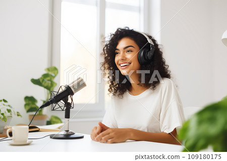 Woman podcaster recording audio podcast with microphone from home studio Woman podcaster recording audio podcast with microphone from home studio 109180175