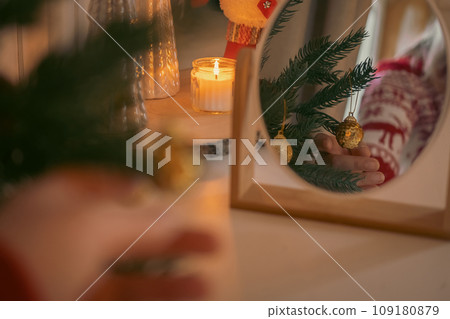Beautiful and decorated Christmas tree in the mirror reflection. Christmas mood. Great photo for greeting card. Boho Scandinavian Style Design. Close up of Christmas tree adorning. New Year decoration Beautiful and decorated Christmas tree in the mirror reflection. Christmas mood. Great photo for greeting card. Boho Scandinavian Style Design. Close up of Christmas tree adorning. New Year decoration 109180879