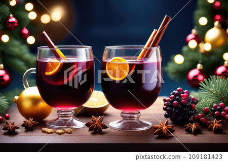 Christmas drink - mulled wine with cinnamon, anise and oranges on rustic table against the Christmas tree and blurry lights. Christmas drink - mulled wine with cinnamon, anise and oranges on rustic table against the Christmas tree and blurry lights. 109181423