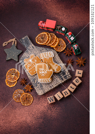 Beautiful delicious sweet winter Christmas gingerbread cookies on a bronze textured background 109182121