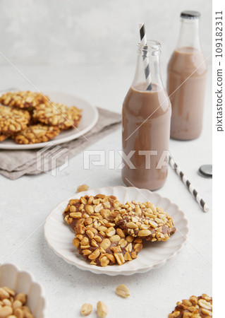A heap of Portugues traditional peanut cookies known as Bolachas de Amendoim on the white plate A heap of Portugues traditional peanut cookies known as Bolachas de Amendoim on the white plate 109182311