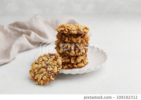 A heap of Portugues traditional peanut cookies known as Bolachas de Amendoim on the white plate 109182312