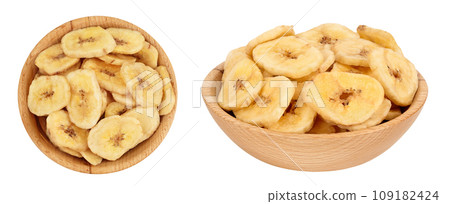 Dried banana chips in wooden bowl isolated on white background with full depth of field. Top view. Flat lay Dried banana chips in wooden bowl isolated on white background with full depth of field. Top view. Flat lay 109182424