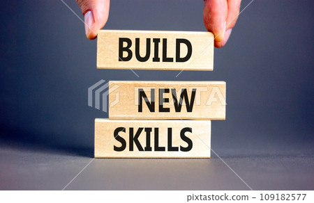 Build new skills symbol. Concept word Build new skills on beautiful wooden block. Businessman hand. Beautiful grey table grey background. Business, education build new skills concept. Copy space. Build new skills symbol. Concept word Build new skills on beautiful wooden block. Businessman hand. Beautiful grey table grey background. Business, education build new skills concept. Copy space. 109182577