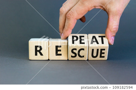 Rescue and repeat symbol. Concept words Rescue Repeat on wooden block. Beautiful grey table grey background. Businessman hand. Business rescue and repeat concept. Copy space. 109182594