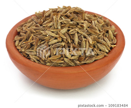 Cumin whole over white background Cumin whole over white background 109183484
