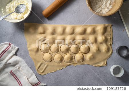 Cooking ravioli with ricotta and cottage cheese filling to dough. 109183726