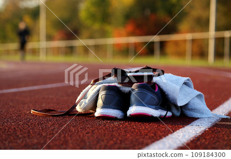 Shoes and parts of women on athletic track 109184300