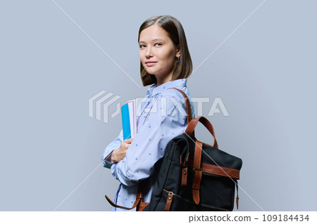 Portrait of young university female student on gray background Portrait of young university female student on gray background 109184434