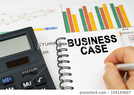 There is a calculator on the table, business charts, a man made a note in a notebook - Business Case There is a calculator on the table, business charts, a man made a note in a notebook - Business Case 109184607