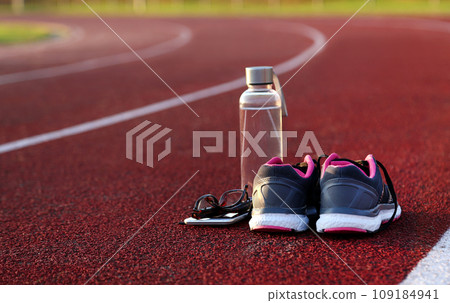 Water bottle and shoes on athletic track Water bottle and shoes on athletic track 109184941