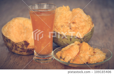 Medicinal Bael fruit with juice in a glass Medicinal Bael fruit with juice in a glass 109185406