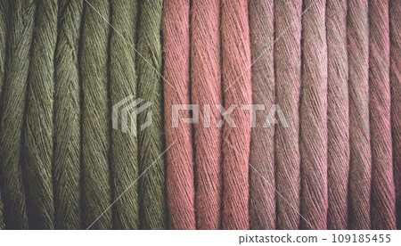 olive green and coral pink yarn closeup; 16:9 background / wallpaper 109185455