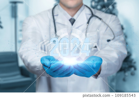 Doctor shows the year 2024 on a blurred background. Doctor shows the year 2024 on a blurred background. 109185543
