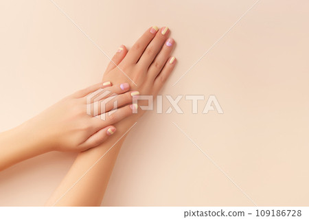 Fashionable minimal spring summer nail design. Beautiful yellow lavender manicure on begie background Fashionable minimal spring summer nail design. Beautiful yellow lavender manicure on begie background 109186728