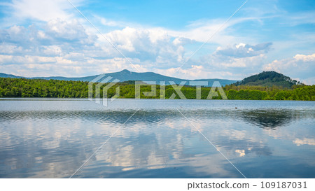 Landscape with Jested Mountain ridge reflected in water of Hamr Lake, or Hamr Pond. Czech Republic 109187031