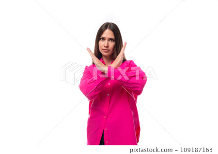 strict young brunette lady dressed in a bright pink shirt crossed her arms strict young brunette lady dressed in a bright pink shirt crossed her arms 109187163
