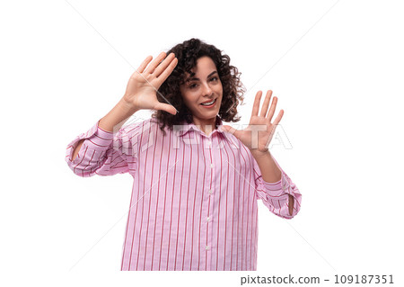 confident young office secretary woman dressed in a striped pink shirt gesturing with her hands confident young office secretary woman dressed in a striped pink shirt gesturing with her hands 109187351