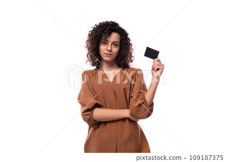 young pretty businesswoman dressed in brown blouse shows plastic card mockup young pretty businesswoman dressed in brown blouse shows plastic card mockup 109187375