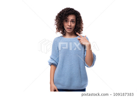 young curly brunette woman dressed in a blue sweater is brainstorming young curly brunette woman dressed in a blue sweater is brainstorming 109187383
