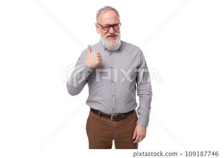 successful grandfather with a gray beard and mustache in glasses dressed in a shirt and trousers on 109187746