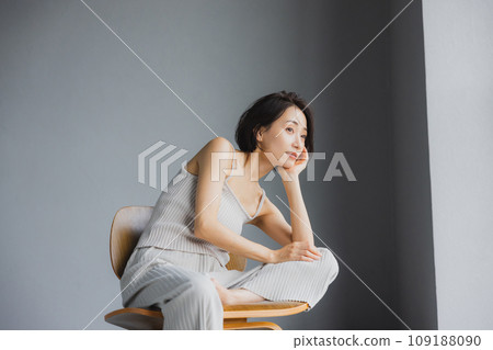 Woman sitting on chair Woman sitting on chair 109188090