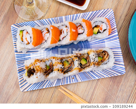 Set of japanese rolls uramaki with eel, avocado, prawns, and salmon 109189244