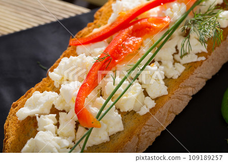 Bulgarian toasted bread with brynza, sweet pepper, greens 109189257