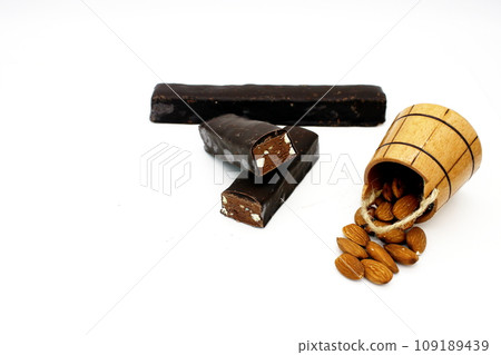Almonds in a wooden barrel and chocolate bar 109189439