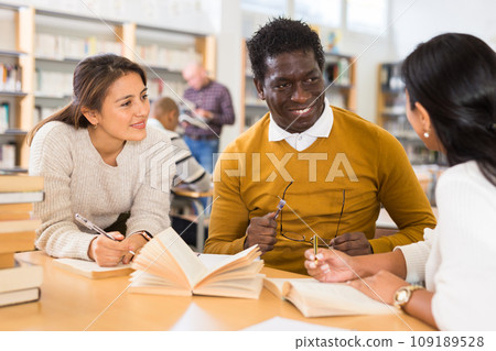 Group of friendly adults people studying in university library 109189528