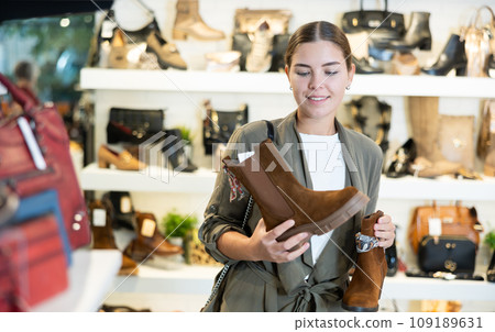 Young woman choosing ankle boots in store Young woman choosing ankle boots in store 109189631
