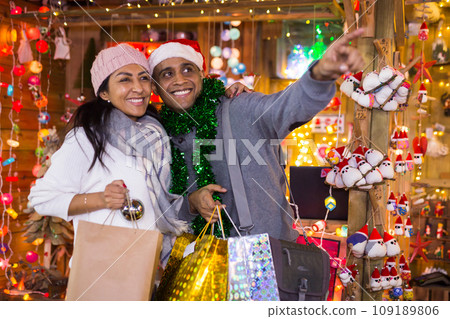 Portrait of couple points to toys at street market Portrait of couple points to toys at street market 109189806